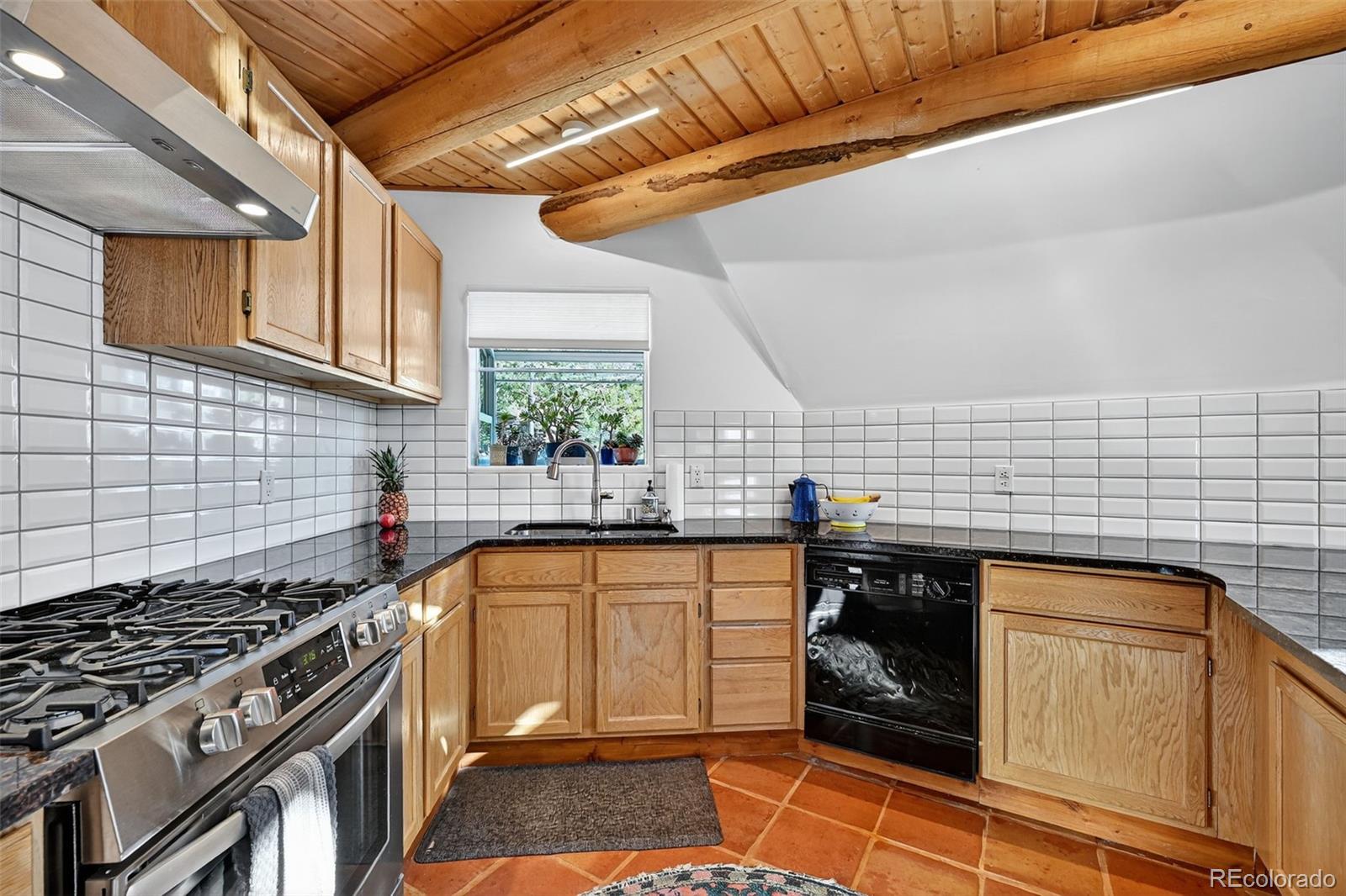 47 Aspen Road Woodland Park, CO 80863 - Photo 11 of 36 a kitchen with a stove and a sink
