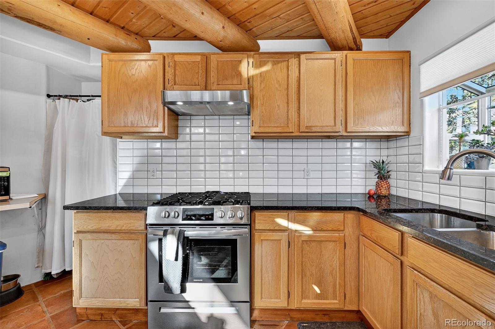 47 Aspen Road Woodland Park, CO 80863 - Photo 12 of 36 a kitchen with a stove window and cabinets