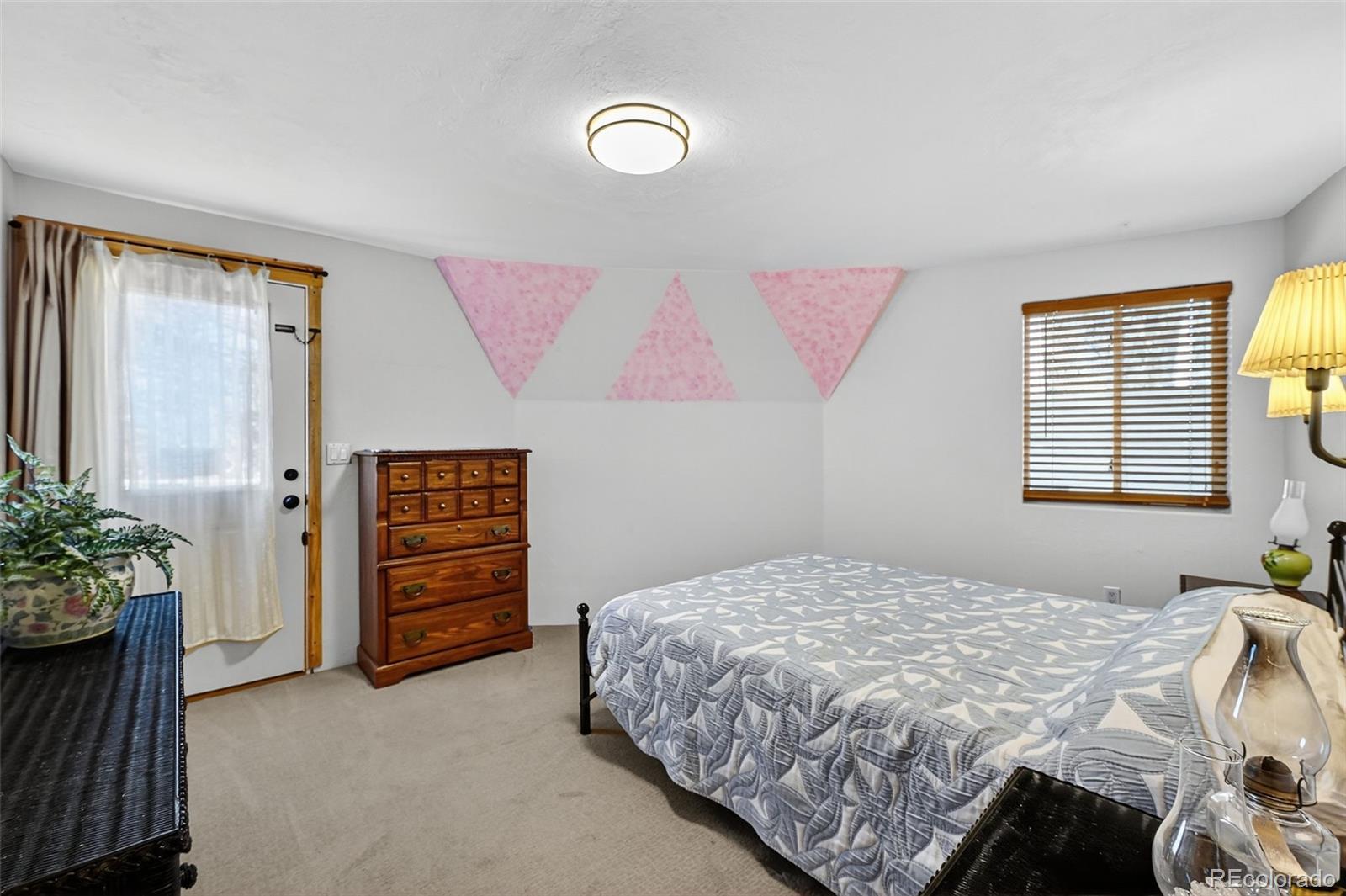 47 Aspen Road Woodland Park, CO 80863 - Photo 14 of 36 a bedroom with a bed and a potted plant