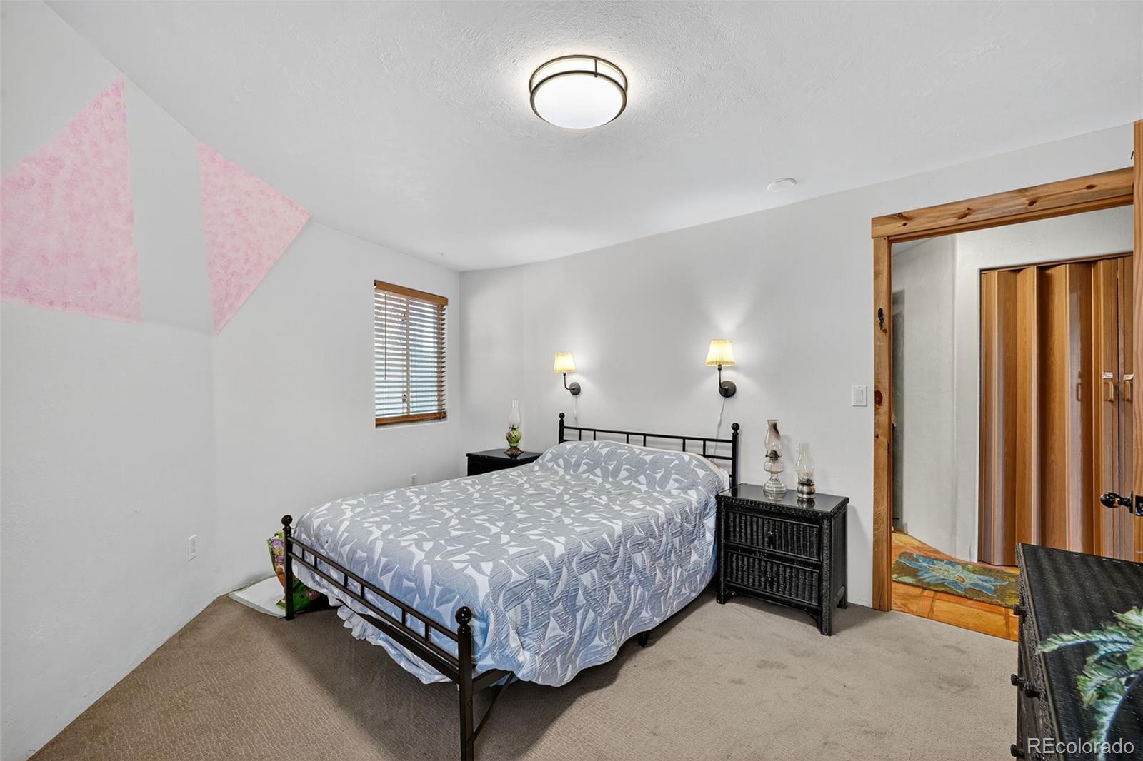 47 Aspen Road Woodland Park, CO 80863 - Photo 15 of 36 a bedroom with a bed and a window