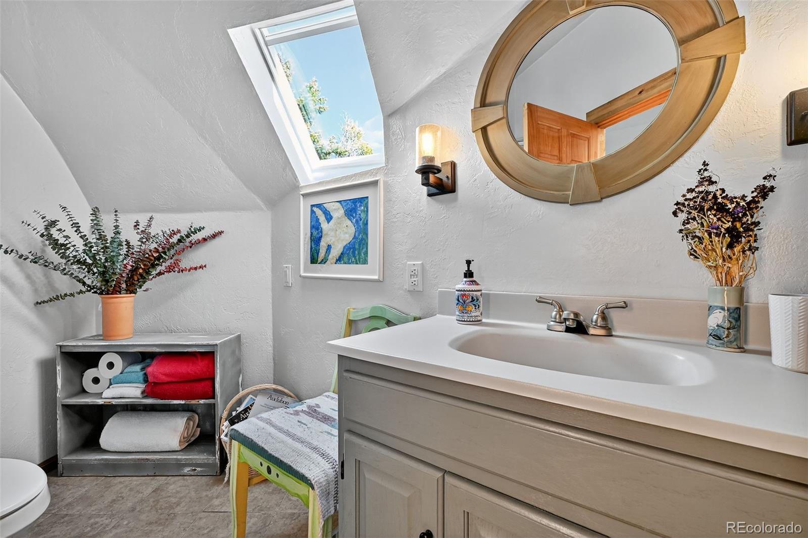47 Aspen Road Woodland Park, CO 80863 - Photo 21 of 36 a bathroom with a sink and a mirror