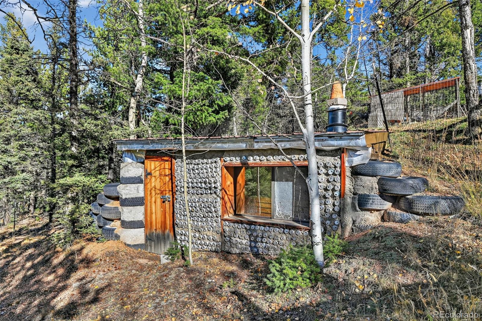 47 Aspen Road Woodland Park, CO 80863 - Photo 23 of 36 a backyard of a house with lots of green space