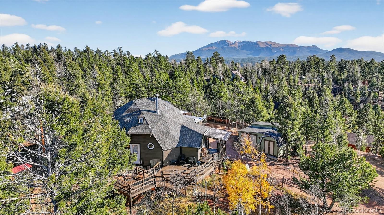 47 Aspen Road Woodland Park, CO 80863 - Photo 31 of 36 a view of a house with a yard and mountain