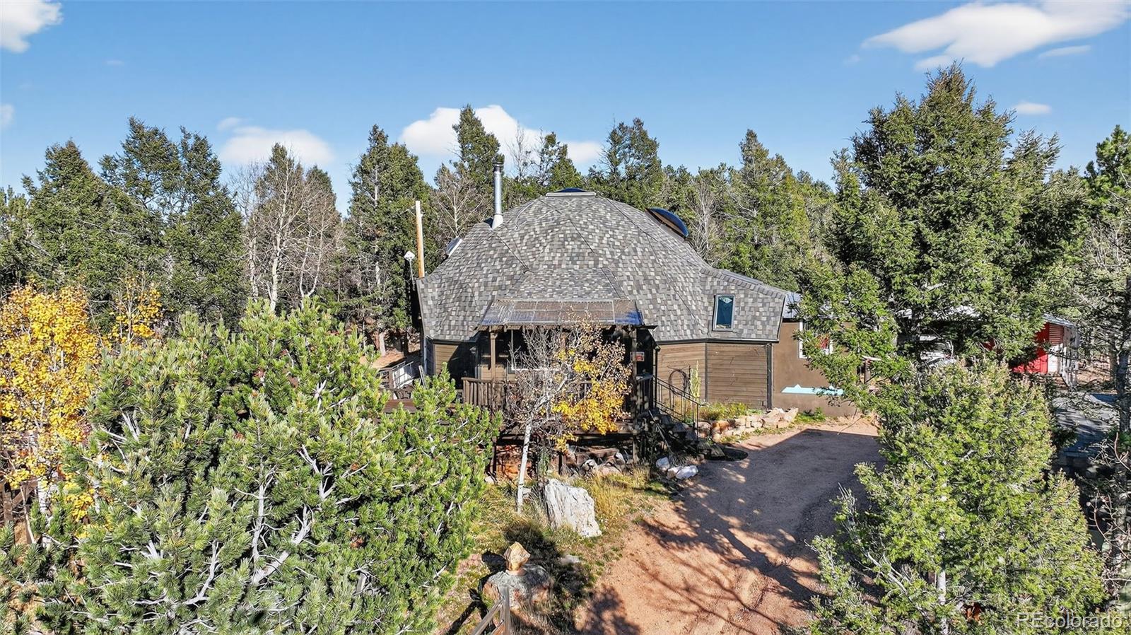 47 Aspen Road Woodland Park, CO 80863 - Photo 32 of 36 view of a house with a yard and sitting area
