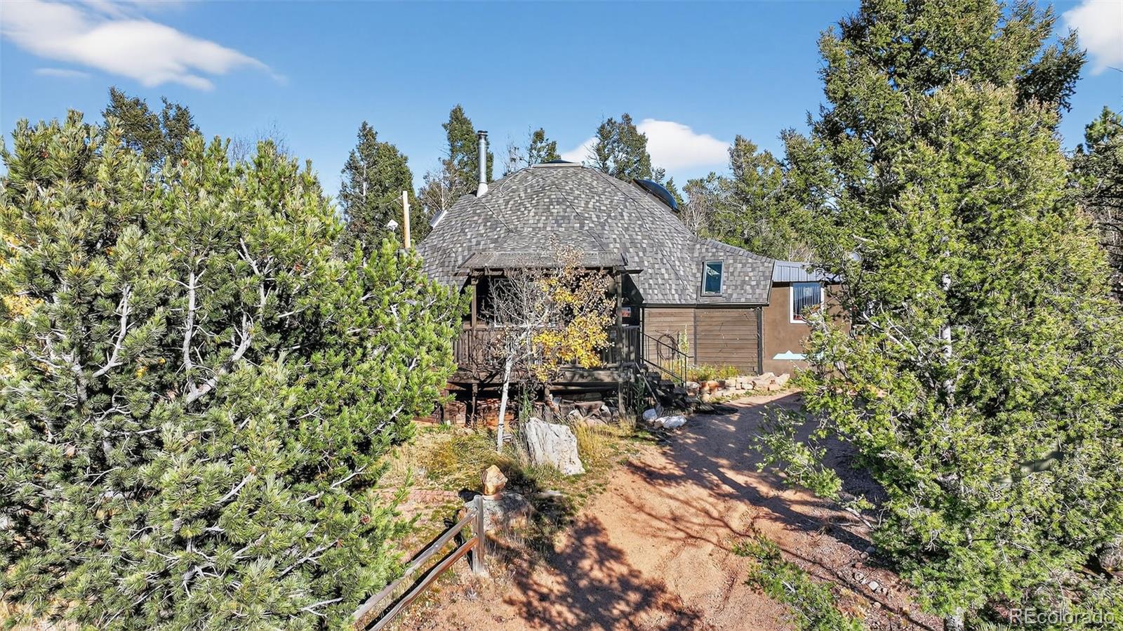 47 Aspen Road Woodland Park, CO 80863 - Photo 35 of 36 a backyard of a house with table and chairs