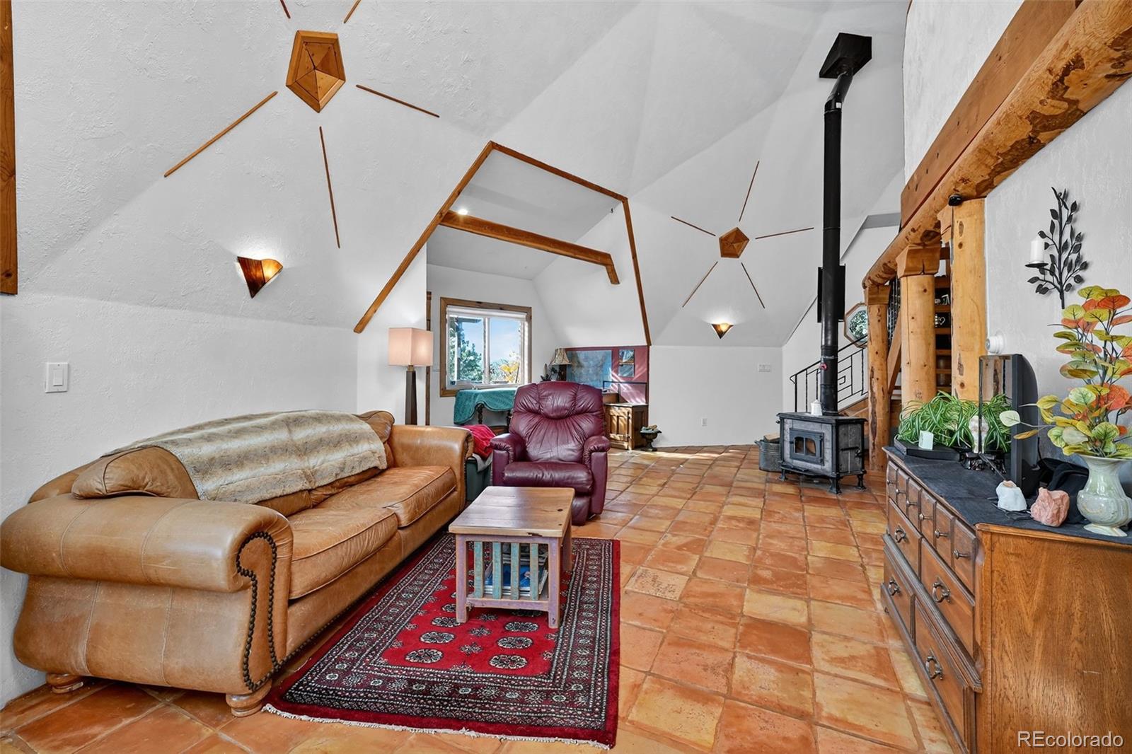 47 Aspen Road Woodland Park, CO 80863 - Photo 6 of 36 a living room with furniture and a potted plant