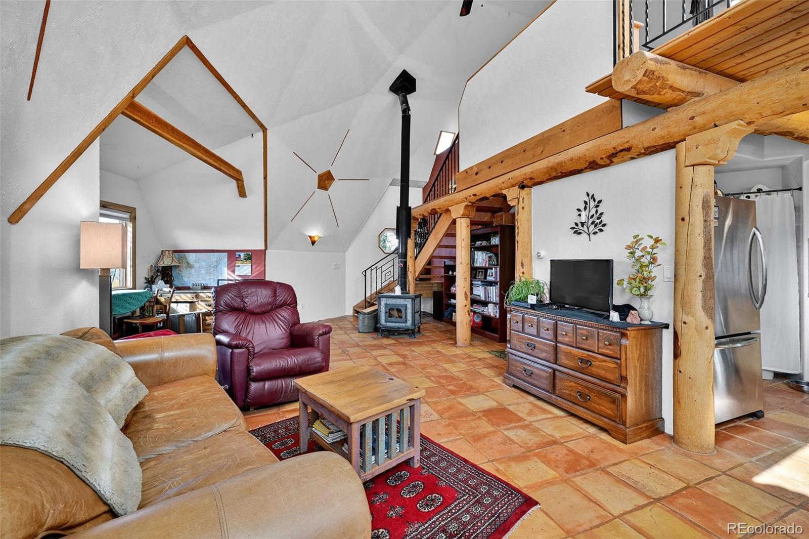 47 Aspen Road Woodland Park, CO 80863 - Photo 7 of 36 a living room with furniture a flat screen tv and kitchen view