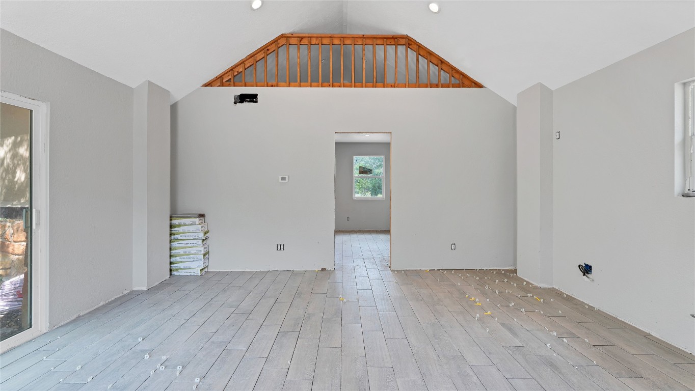 499 Bridgestone Court Lockhart, TX 78644 - Photo 2 of 36 an empty room with wooden floor and windows