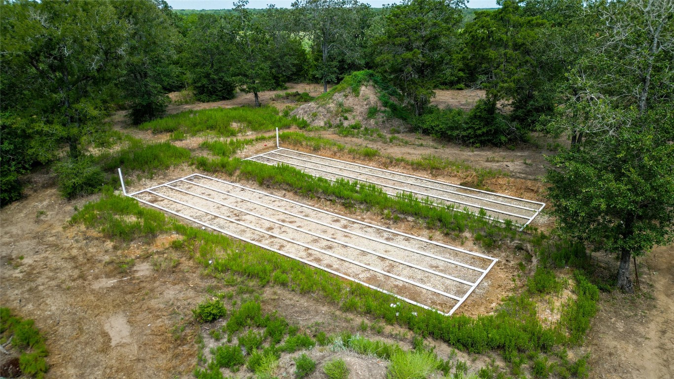 499 Bridgestone Court Lockhart, TX 78644 - Photo 27 of 36 a view of a yard with plants and a bench