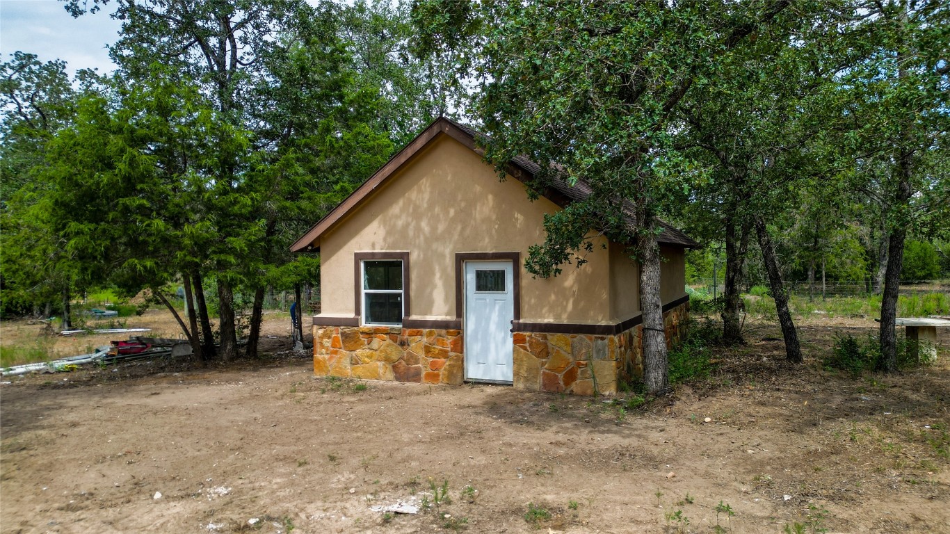 499 Bridgestone Court Lockhart, TX 78644 - Photo 31 of 36 a view of a house with a yard and tree