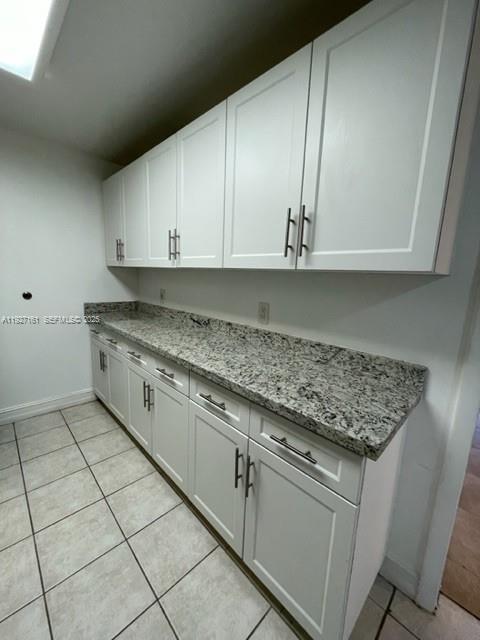 9721 East Bay Harbor Drive, Unit 3C Bay Harbor Islands, FL 33154 - Photo 14 of 17 a kitchen with granite countertop a sink and a stove