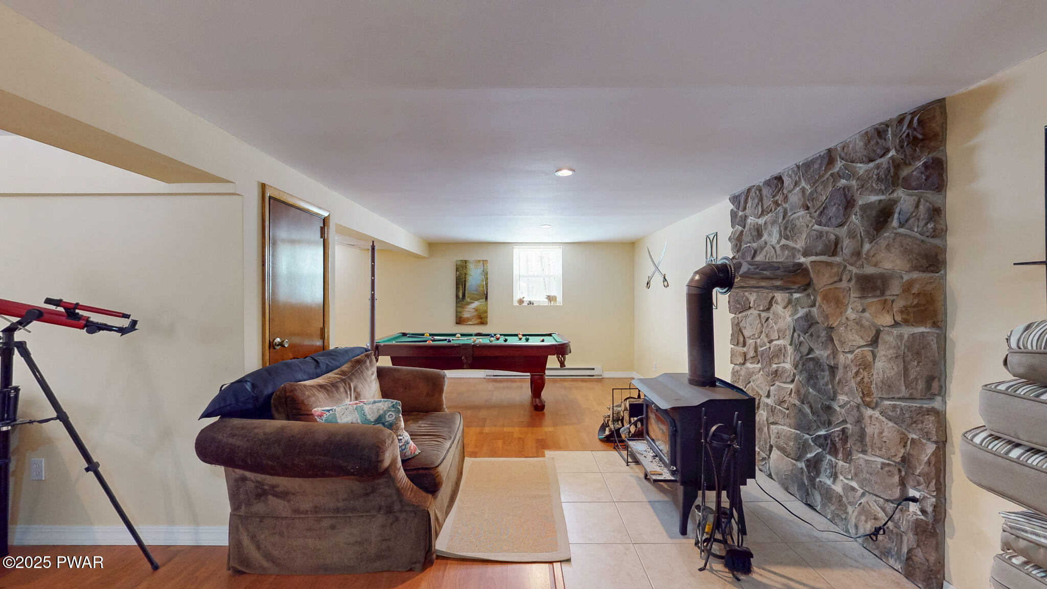 269 High Ridge Road Dingmans Ferry, PA 18328 - Photo 21 of 32 a living room with furniture and a fireplace