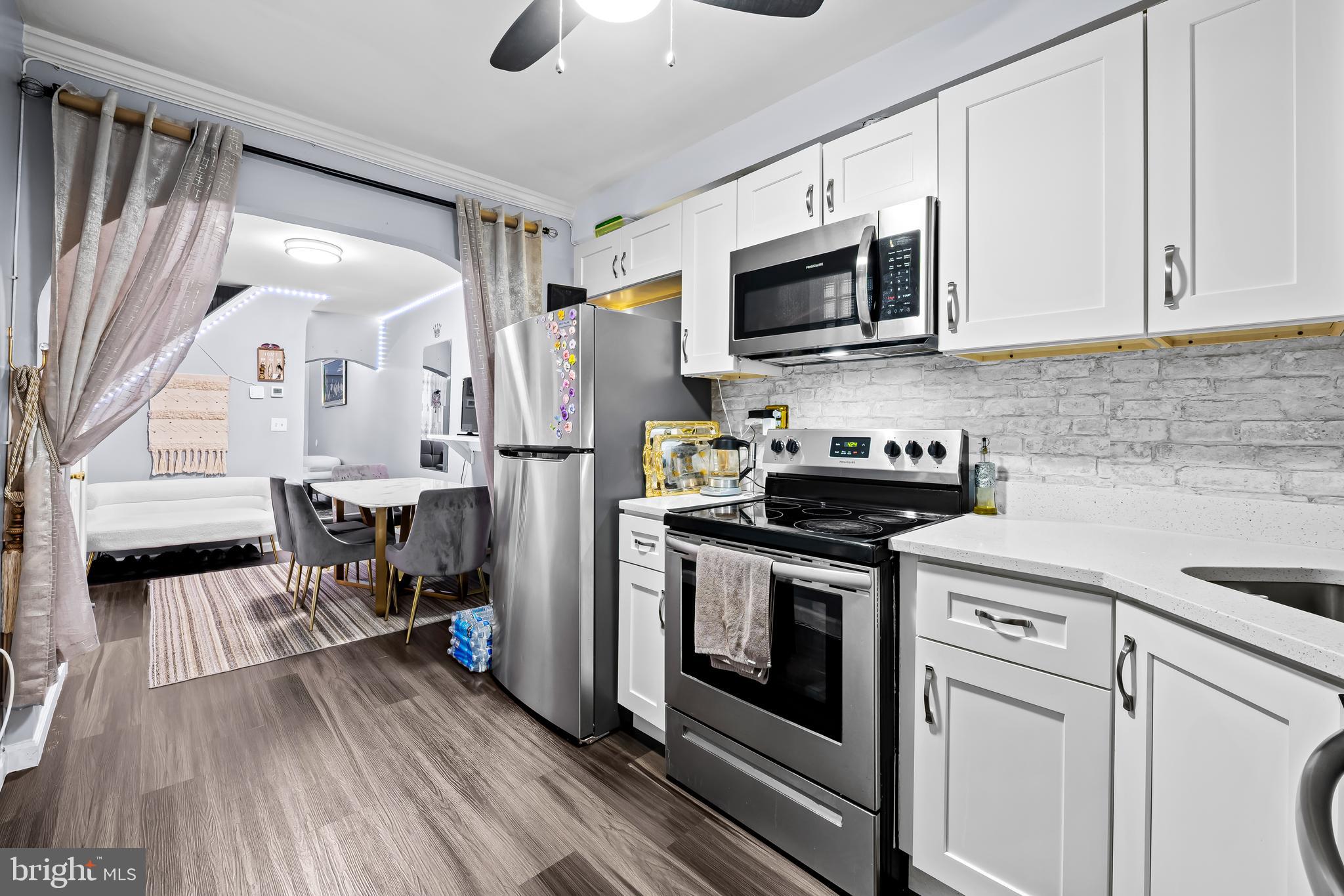 236 South Gilmor Street Baltimore, MD 21223 - Photo 1 of 28 a kitchen with stainless steel appliances a stove microwave and refrigerator