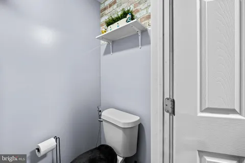 a white toilet sitting next to a shower