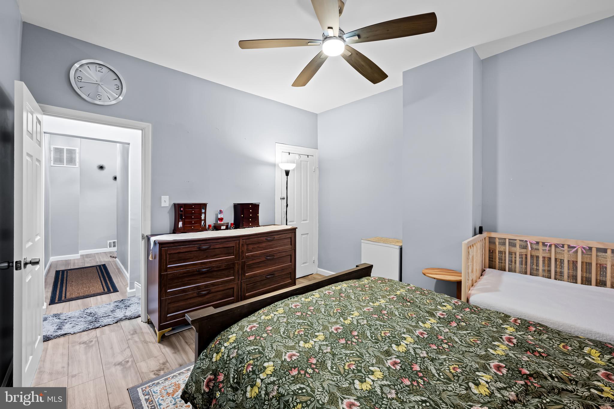236 South Gilmor Street Baltimore, MD 21223 - Photo 17 of 28 a bedroom with a bed and a chandelier