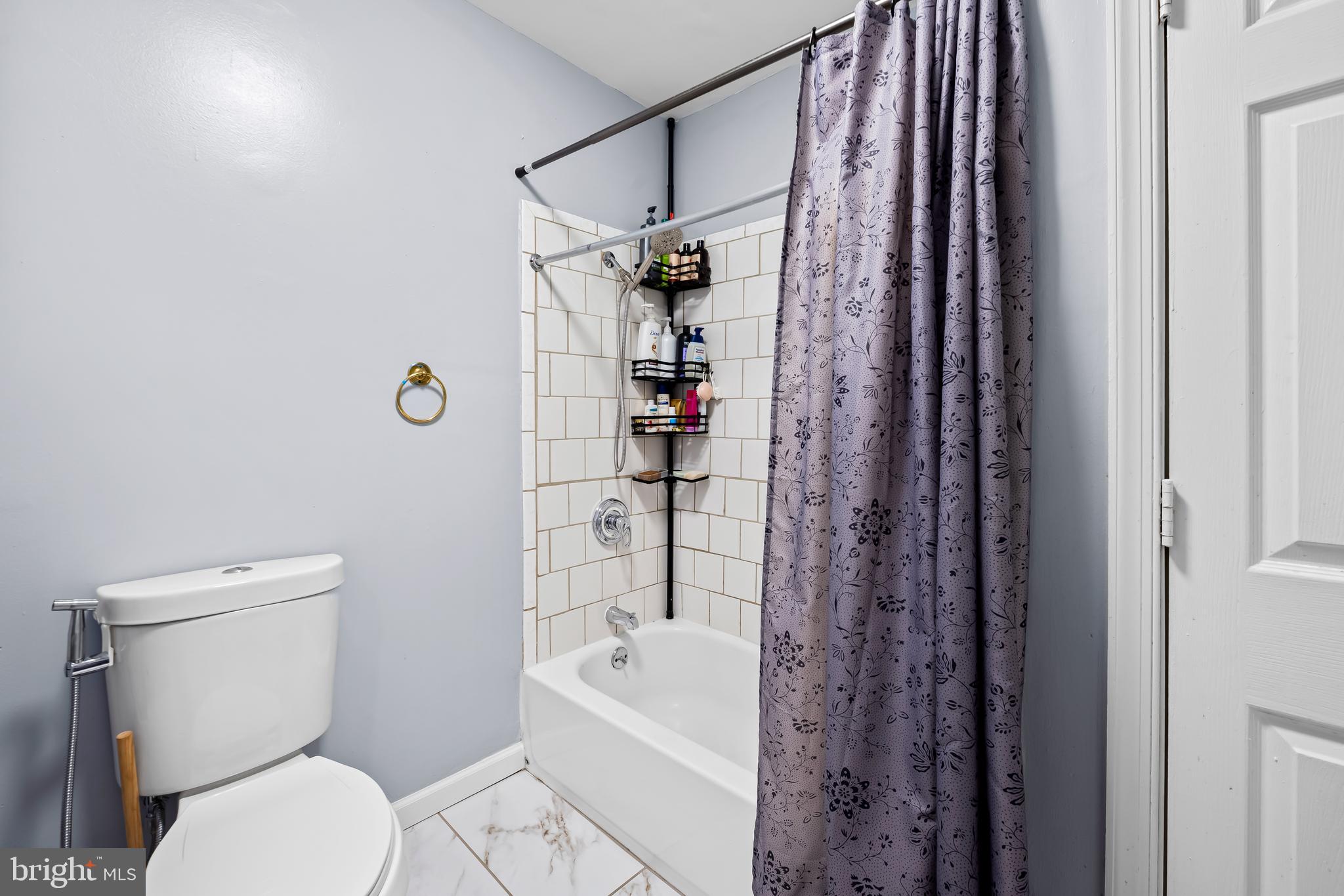 236 South Gilmor Street Baltimore, MD 21223 - Photo 22 of 28 a bathroom with a toilet and a shower