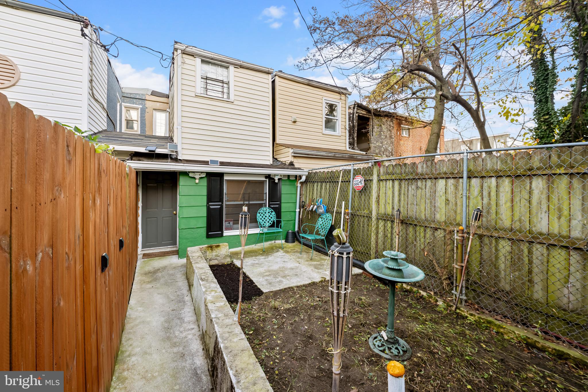 236 South Gilmor Street Baltimore, MD 21223 - Photo 26 of 28 a view of a house with a tub and wooden bench in a patio