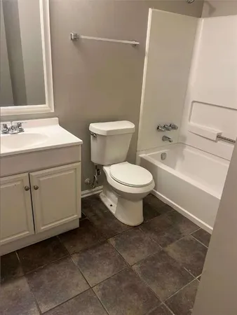 an empty room with a fireplace and wooden floor