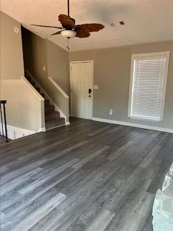 a view of an entryway with wooden floor