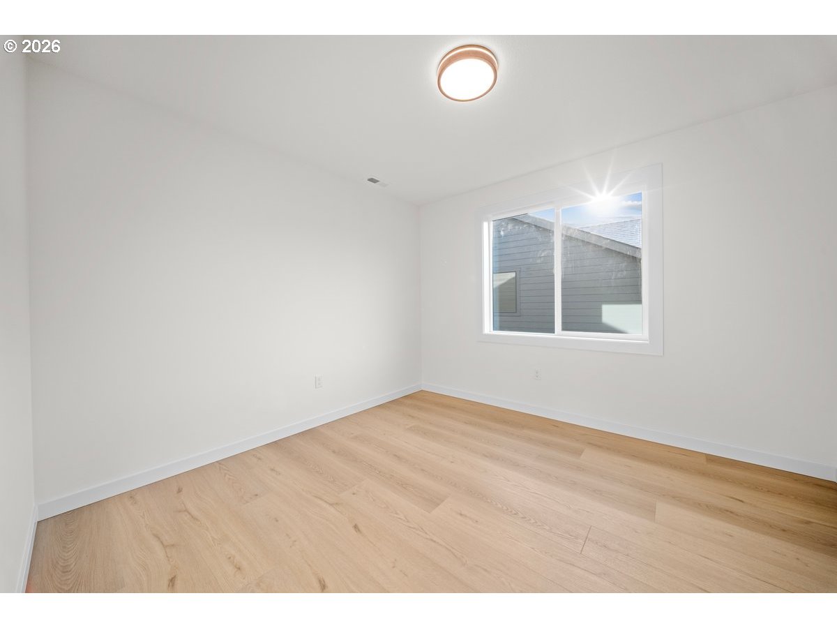 401 South 1st Street Silverton, OR 97381 - Photo 11 of 12 a view of an empty room with wooden floor and a window