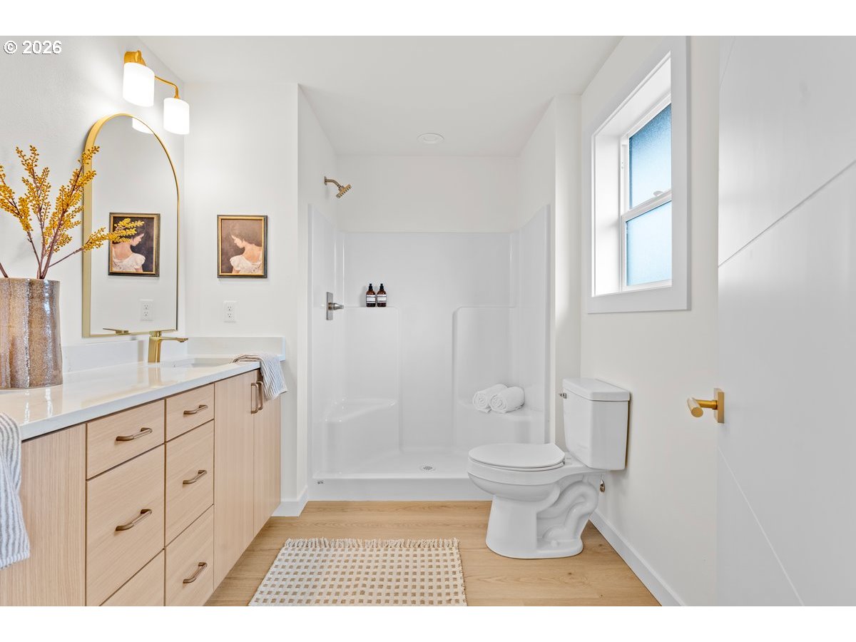 401 South 1st Street Silverton, OR 97381 - Photo 8 of 12 a bathroom with a granite countertop sink toilet and a mirror