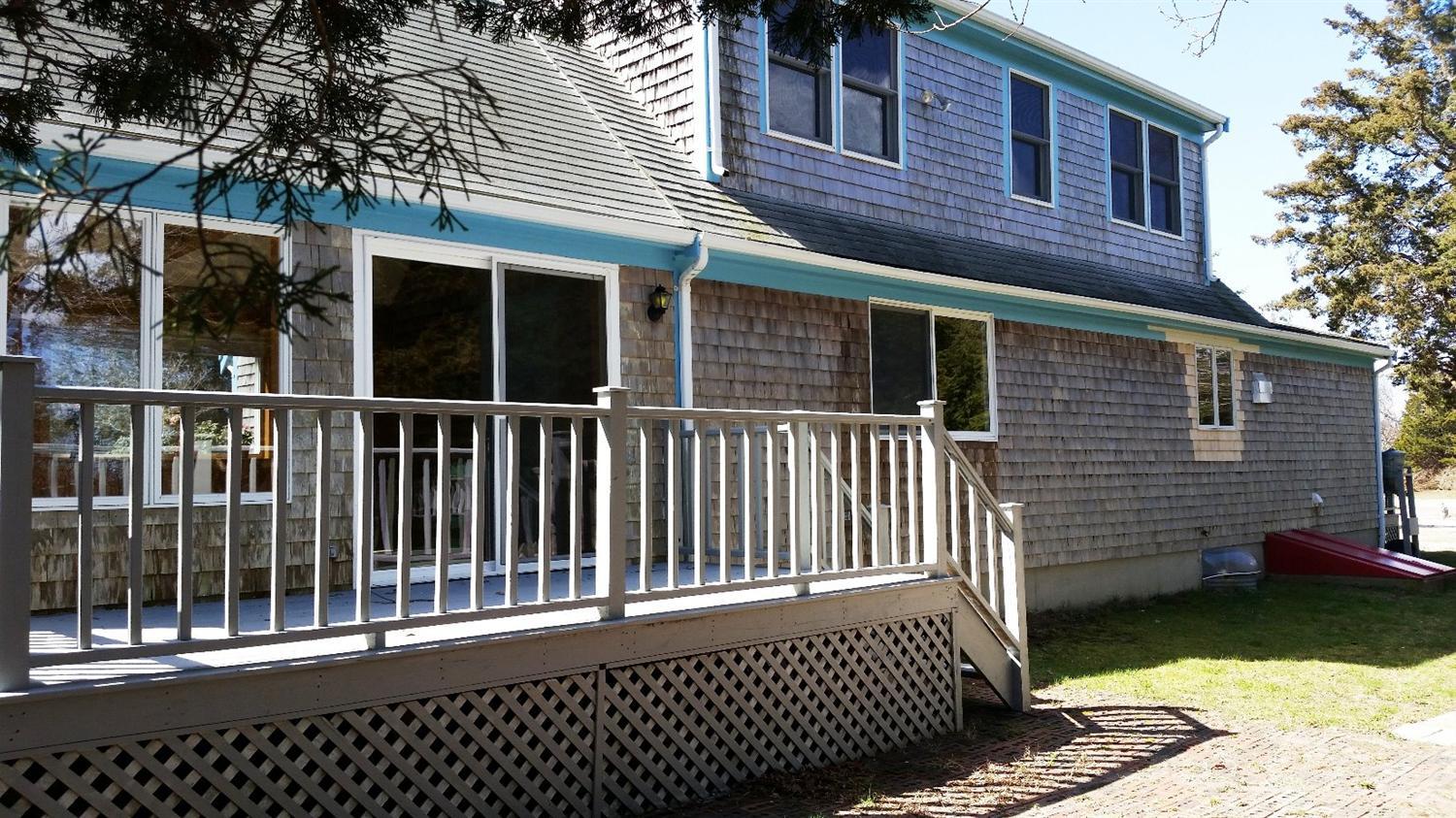 60 John Thomas Road Eastham, MA 02642 - Photo 3 of 14 a view of a house with a small yard and wooden fence