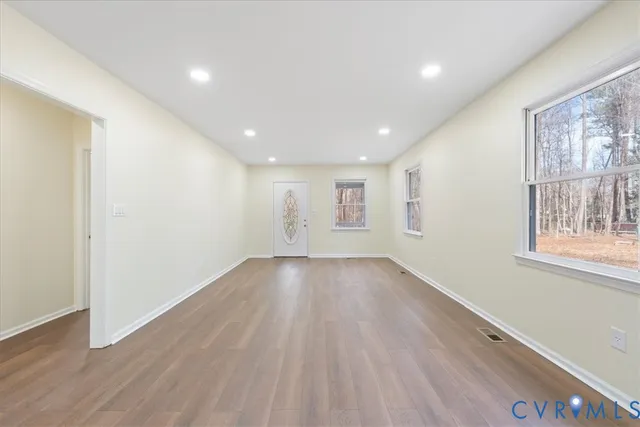 a kitchen with granite countertop white cabinets and a sink