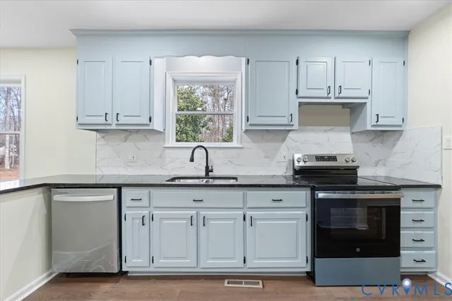 a view of a room with wooden floor and ceiling fan