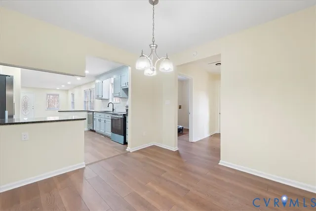 a bathroom with a toilet a sink a mirror and vanity