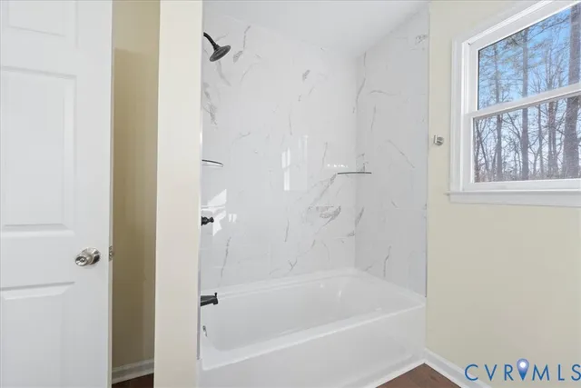 a view of a big room with wooden floor and windows in a room