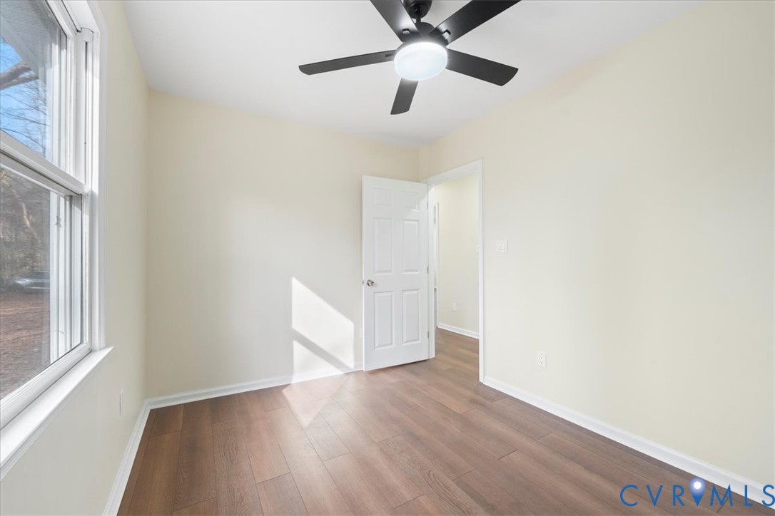 19707 Walker Avenue Colonial Heights, VA 23834 - Photo 25 of 36 an empty room with wooden floor fan and windows