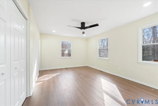 a bathroom with a shower a toilet and a window