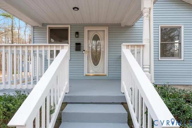 a view of a hallway with wooden floor and entryway