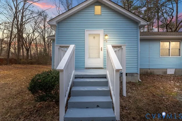 a view of a house with wooden fence and large windows