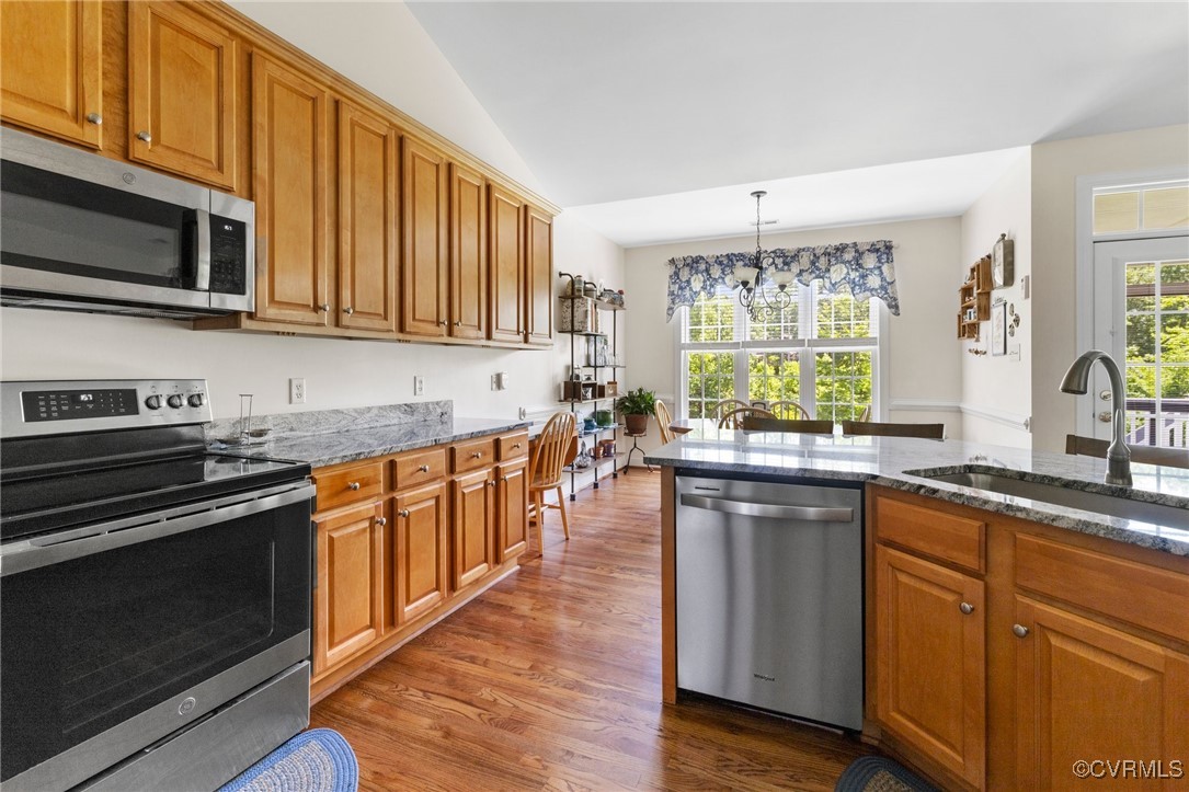1629 Olmstead Drive Powhatan, VA 23139 - Photo 13 of 50 a kitchen with stainless steel appliances granite countertop a stove a sink dishwasher and a microwave oven with wooden floor