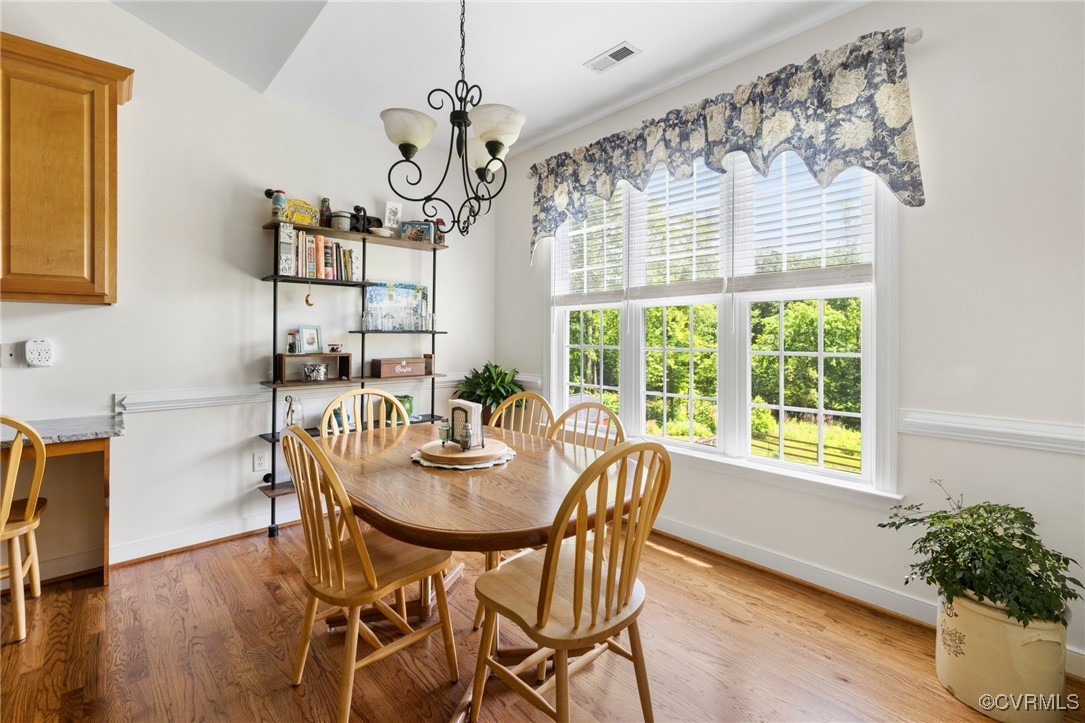 1629 Olmstead Drive Powhatan, VA 23139 - Photo 16 of 50 a view of a dining room with furniture window and wooden floor