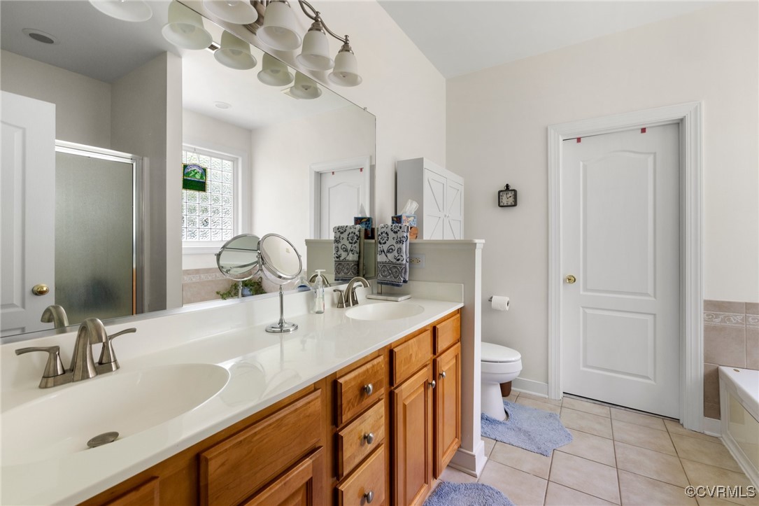 1629 Olmstead Drive Powhatan, VA 23139 - Photo 19 of 50 a bathroom with a sink a vanity and a mirror