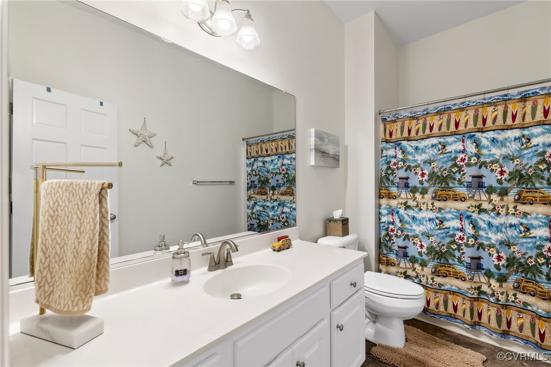 1629 Olmstead Drive Powhatan, VA 23139 - Photo 33 of 50 a bathroom with a sink a toilet and shower curtain