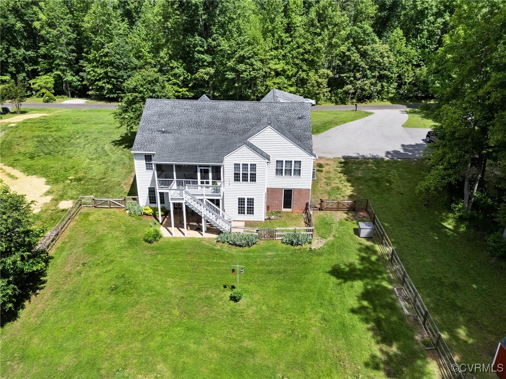 1629 Olmstead Drive Powhatan, VA 23139 - Photo 42 of 50 a view of a white house with a big yard plants and large trees