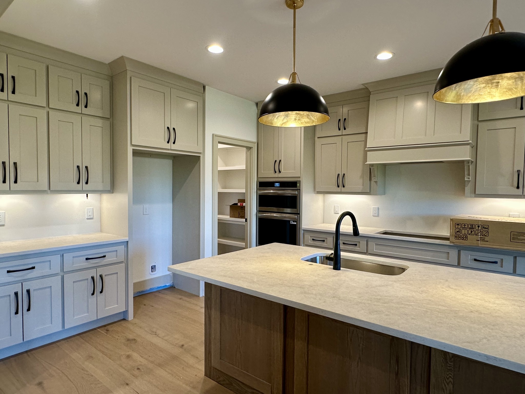 5541 Sinclair Street Murfreesboro, TN 37127 - Photo 5 of 29 a kitchen with kitchen island granite countertop a sink a center island and stainless steel appliances