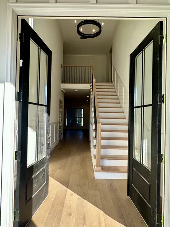 a view of an empty room with window and fire place