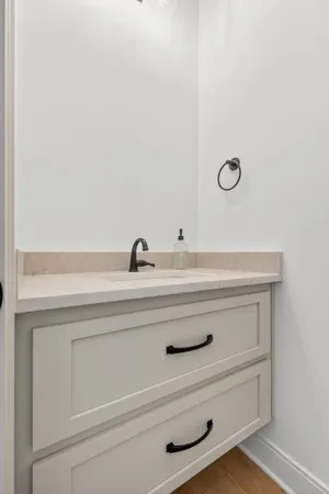 a spacious bathroom with a double vanity sink a mirror and a toilet