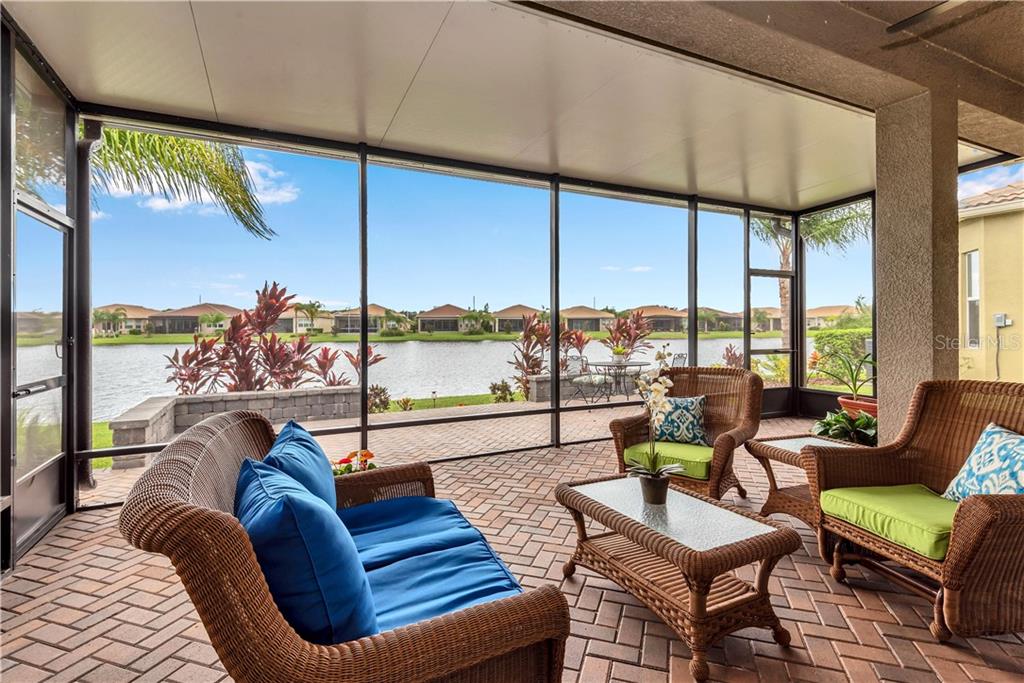 This is FLORIDA LIVING AT ITS BEST - This extended screened Lanai with Brick pavers wraps around and opens to your charming breakfast nook - GREAT VIEWS AND RELAXATION YEAR ROUND - beyond is Open Deck for"Alfresco" dining enhanced by ambient lighting below raised brick walls