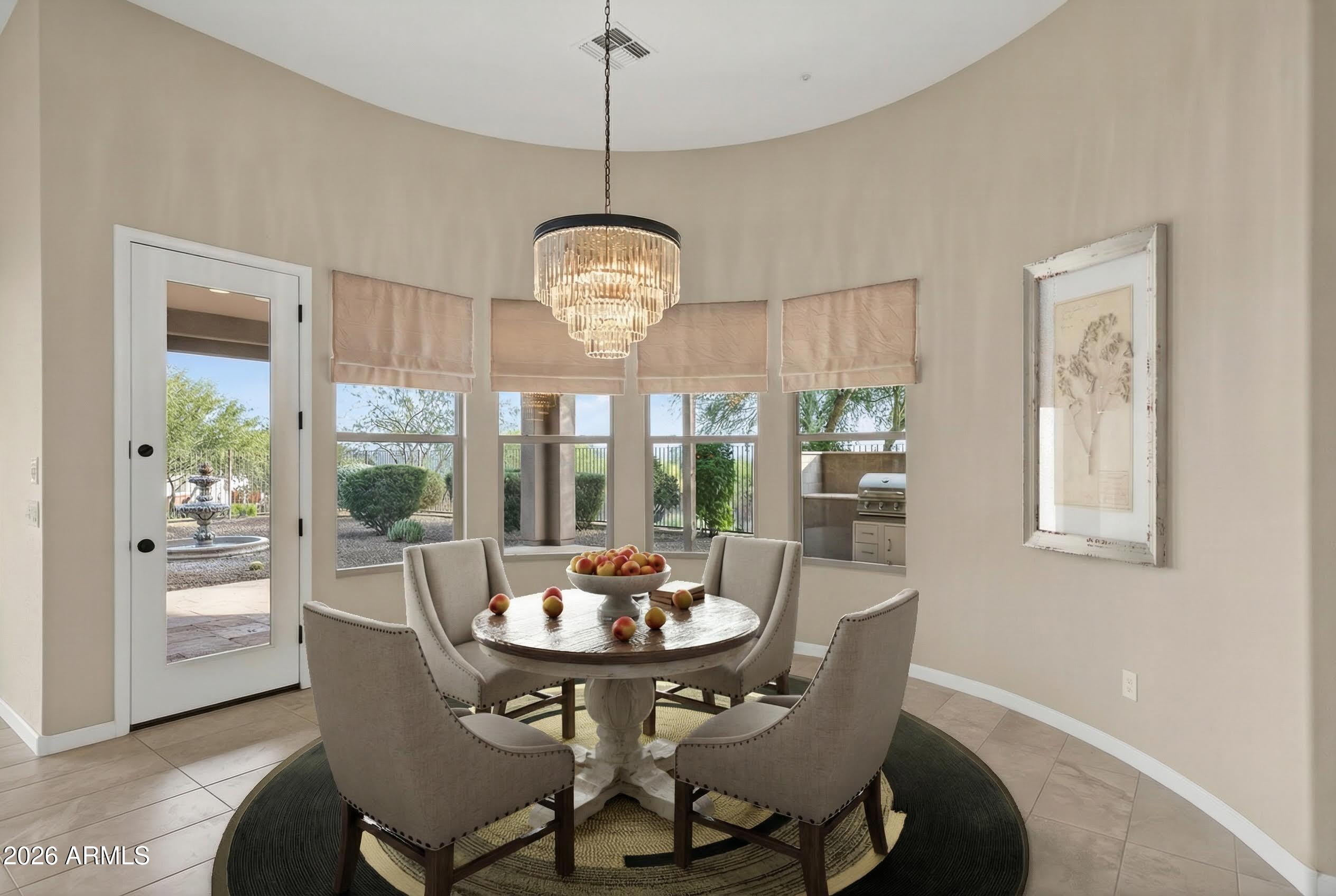 17662 Blaze Lane Rio Verde, AZ 85263 - Photo 12 of 68 a view of a dining room with furniture wooden floor and a chandelier