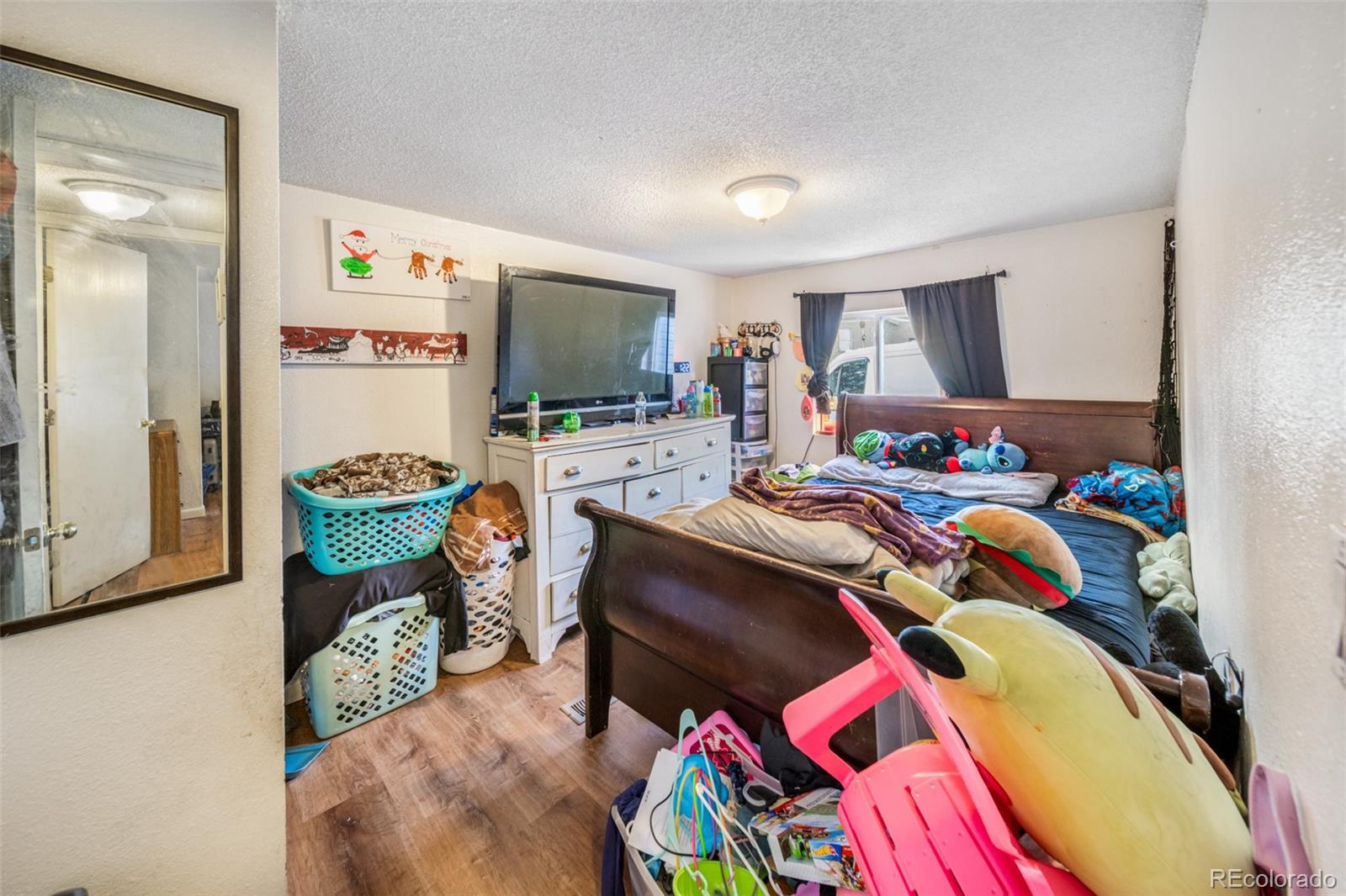 2625 Pheasant Street Denver, CO 80260 - Photo 12 of 18 a bedroom with a bed and a flat screen tv