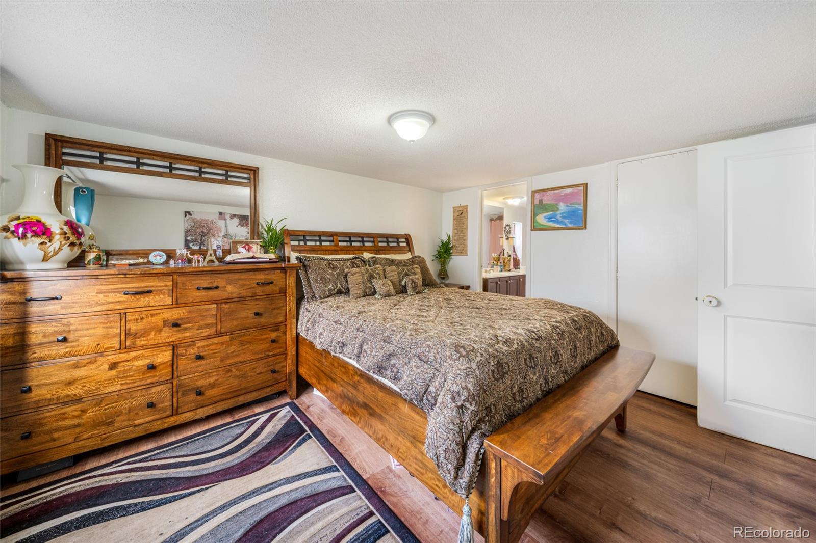 2625 Pheasant Street Denver, CO 80260 - Photo 7 of 18 a bedroom with a bed and wooden floor