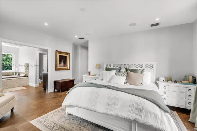 a bedroom with a large bed and a couch