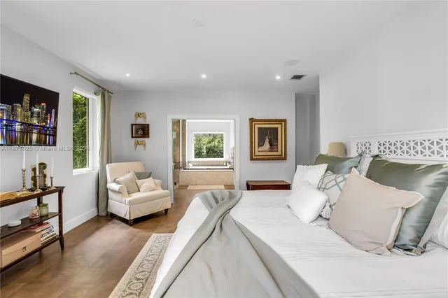 a spacious bathroom with a granite countertop sink and a mirror