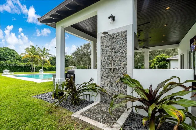 a view of a house with backyard porch and sitting area