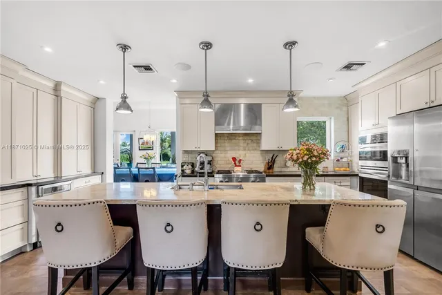 a large kitchen with kitchen island a large island in the center